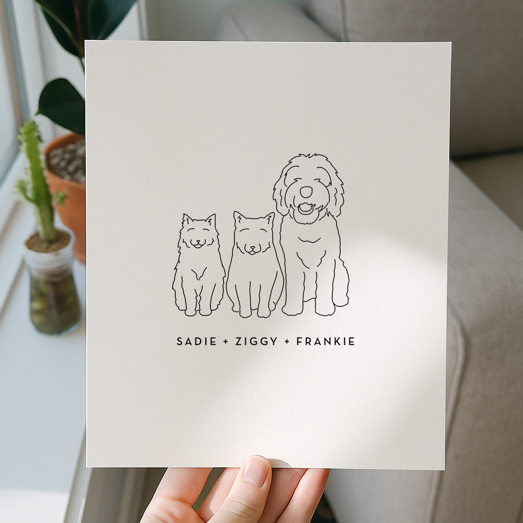 Hand holding a card with line drawings of three dogs and their names in a home setting.